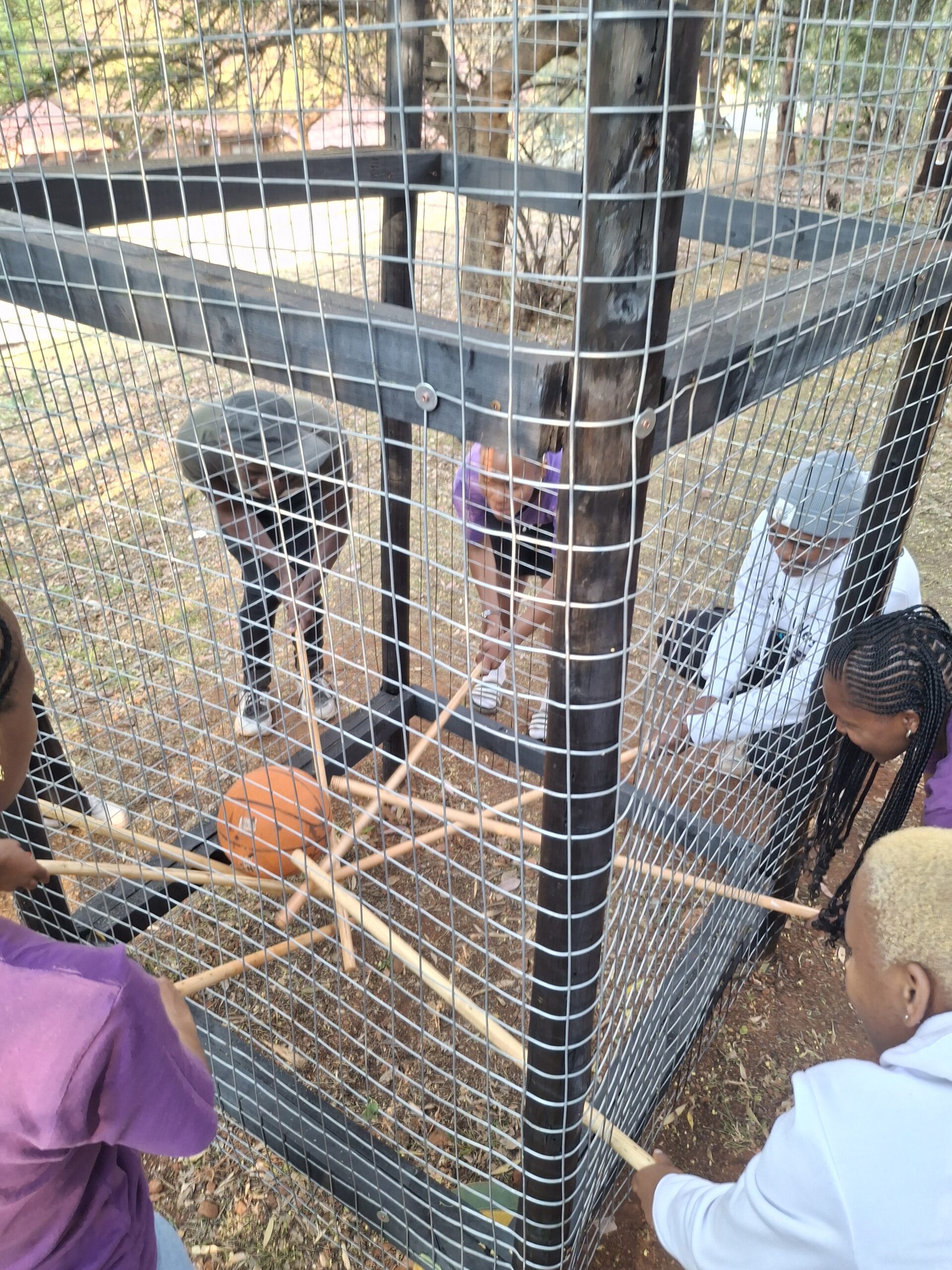 School learners participating in a trapped team-building activity during a leadership camp